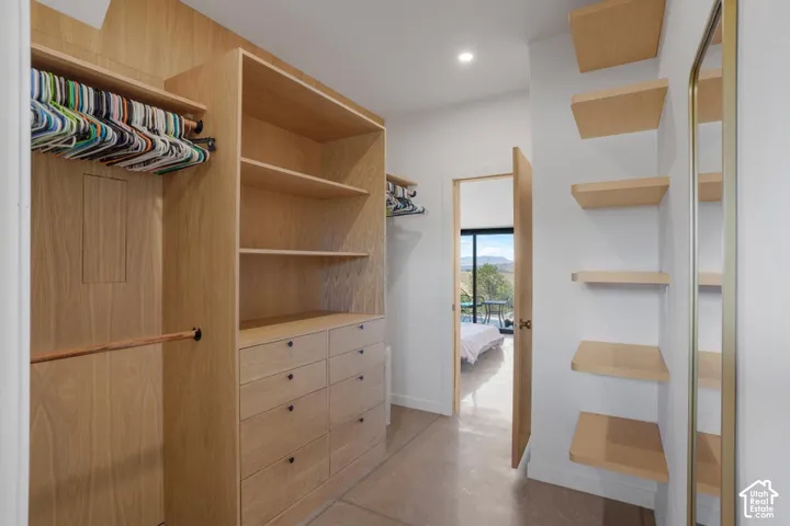 Built-in wood-finish cabinetry featuring open shelving and drawer storage