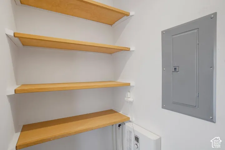 Built-in wood shelves and a white wall-mounted unit