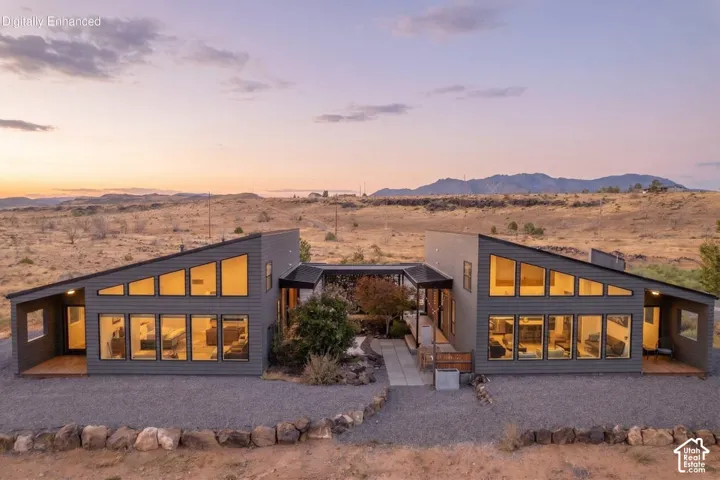 Contemporary exterior design featuring a distinctive angled roofline and extensive window placement