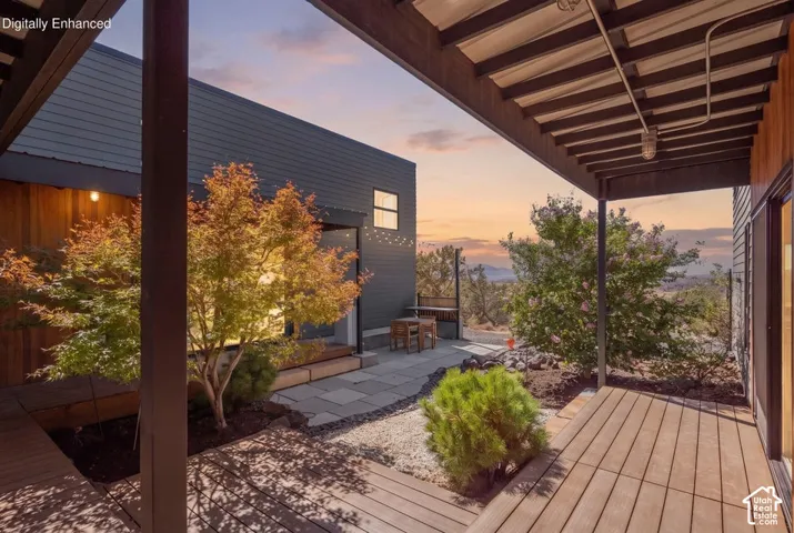 Covered outdoor patio with wood-finish decking and exposed beam ceiling