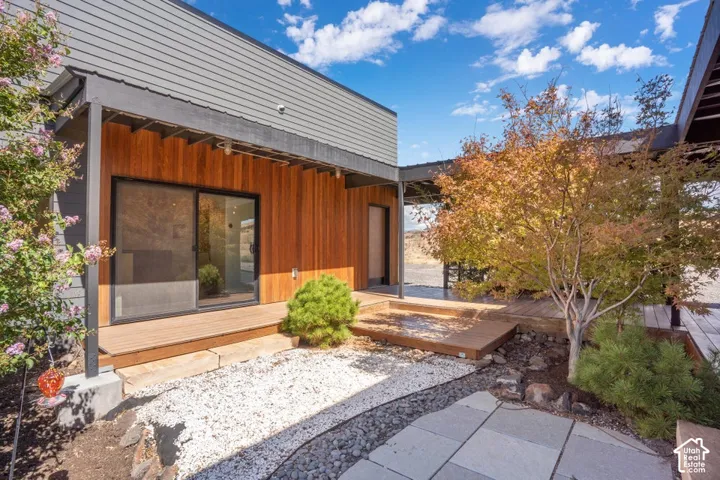 Modern exterior featuring horizontal siding, wood paneling, and a sliding glass door