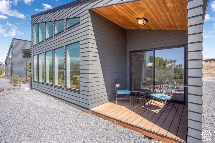 Horizontal siding exterior with a wood-finish ceiling on the covered patio