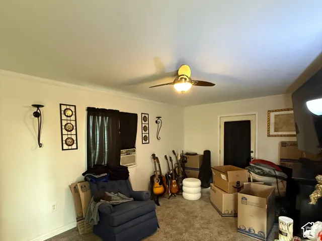 Wall-to-wall carpeting and a ceiling fan with integrated lighting