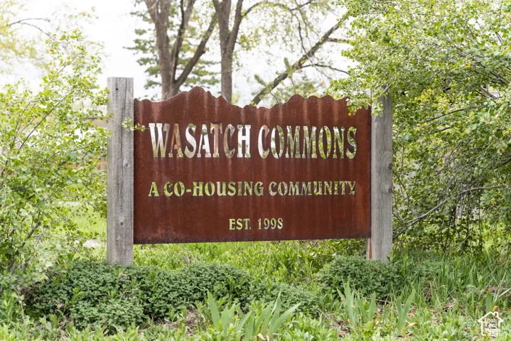 Custom metal sign with a corrugated top edge, supported by wooden posts