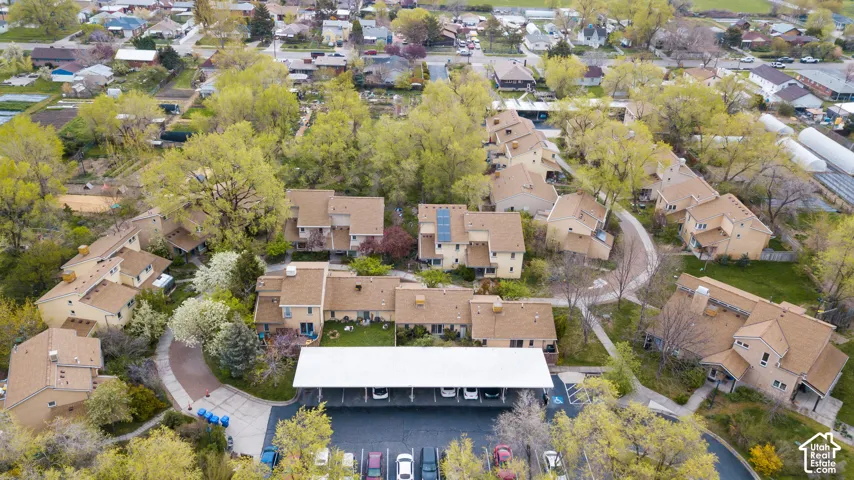 Community featuring multi-level residences, an integrated parking structure, and mature landscaping