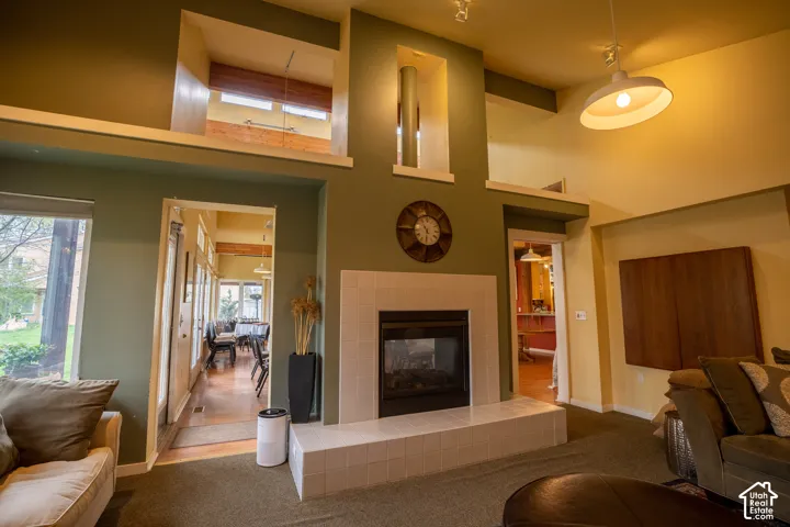 Built-in fireplace with a tiled surround, high ceilings, and recessed architectural details