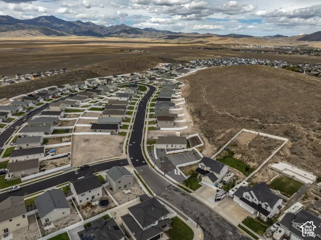 Expansive community featuring numerous residential properties and undeveloped land parcels