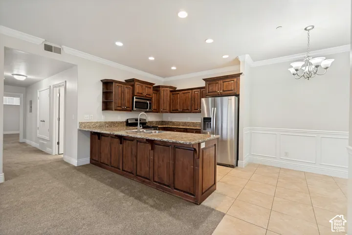 Kitchen featuring wood cabinetry, granite countertops, stainless steel appliances, and recessed lighting