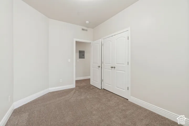 Wall-to-wall carpeting, crisp white walls, and bright white trim