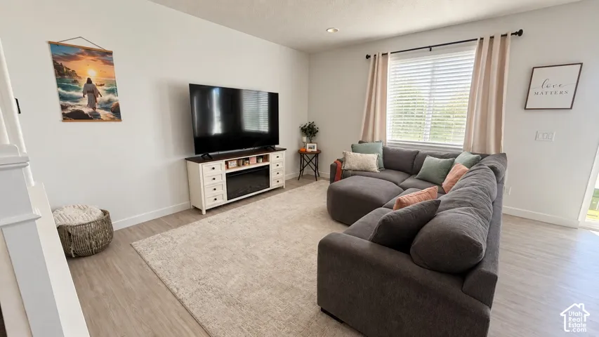 Light wood-finish flooring with white walls
