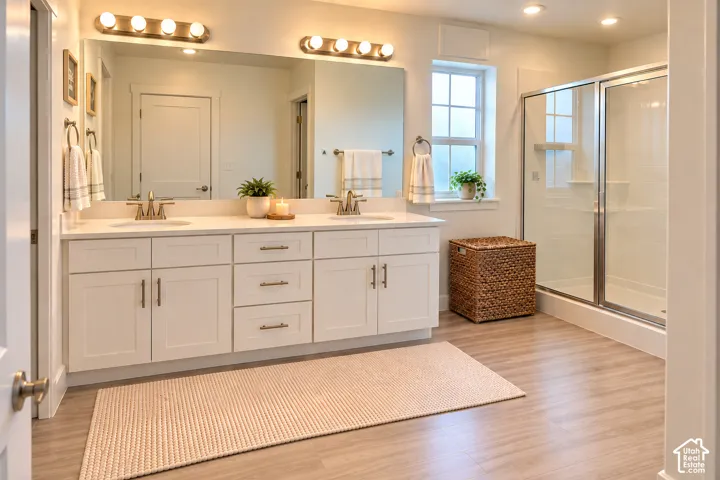 Dual vanity with white cabinetry, integrated sinks, and brushed nickel fixtures