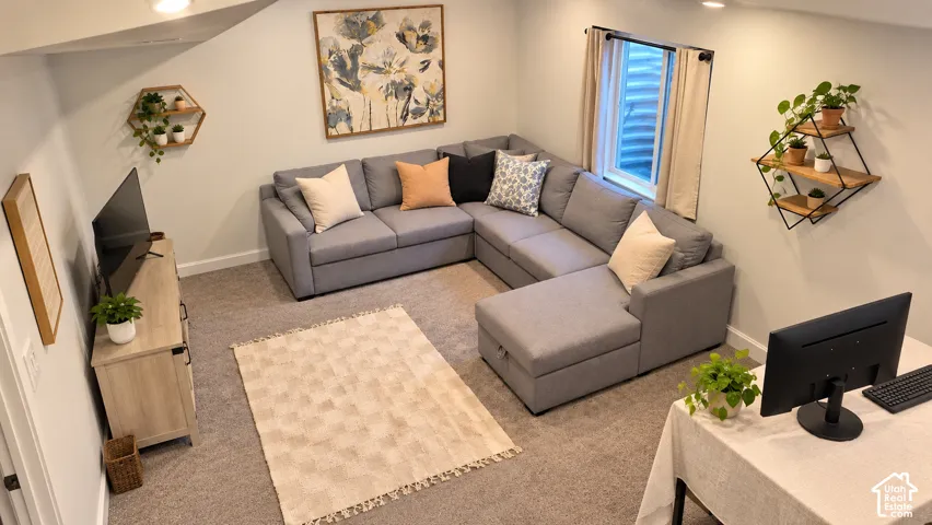 Carpeted living space with recessed lighting and a built-in window