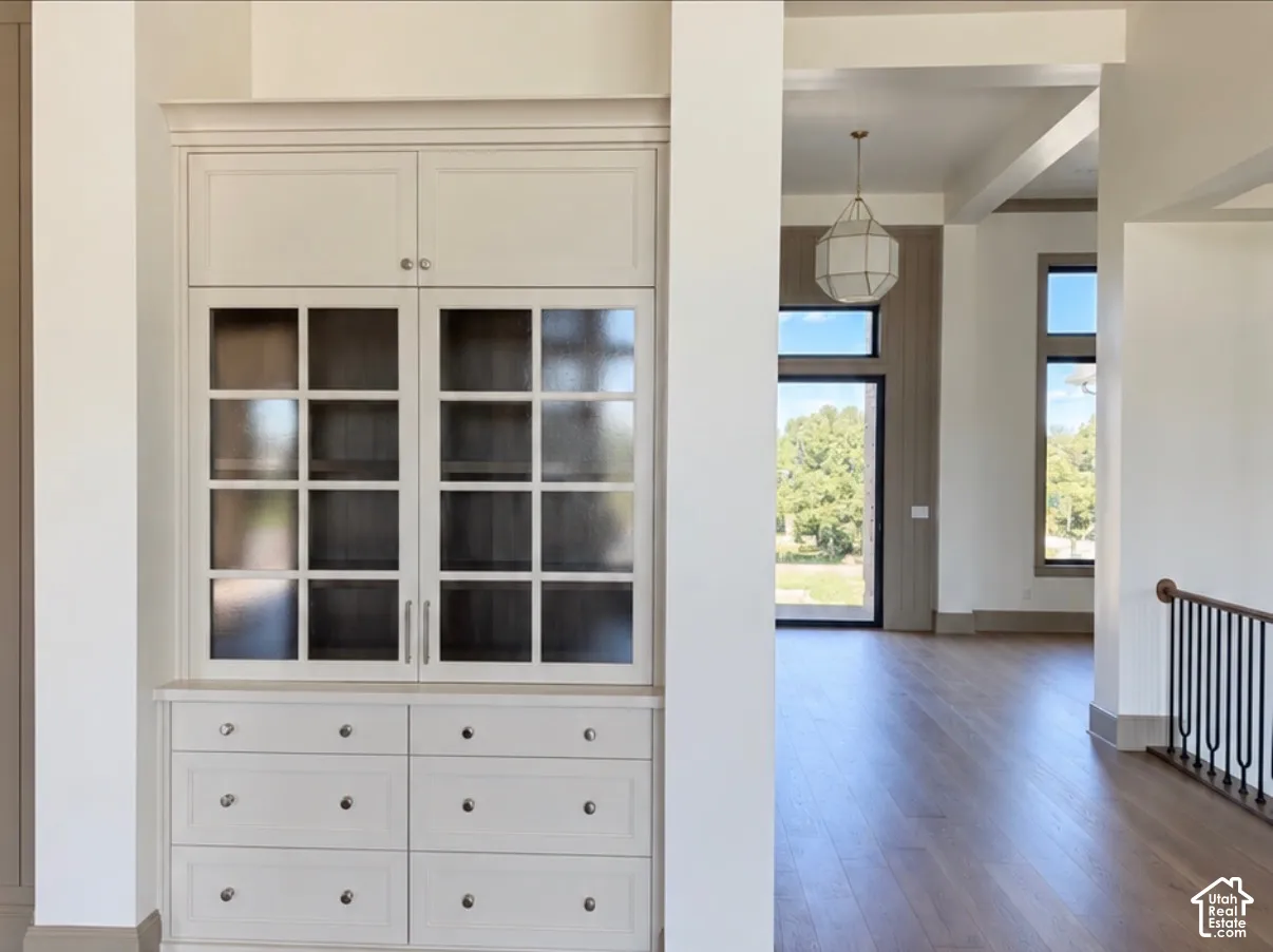 Built-in cabinetry with glass-front upper doors, lower drawers, and panel-front storage