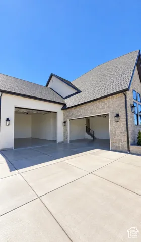 Multi-car garage with concrete drive and epoxy-coated floors