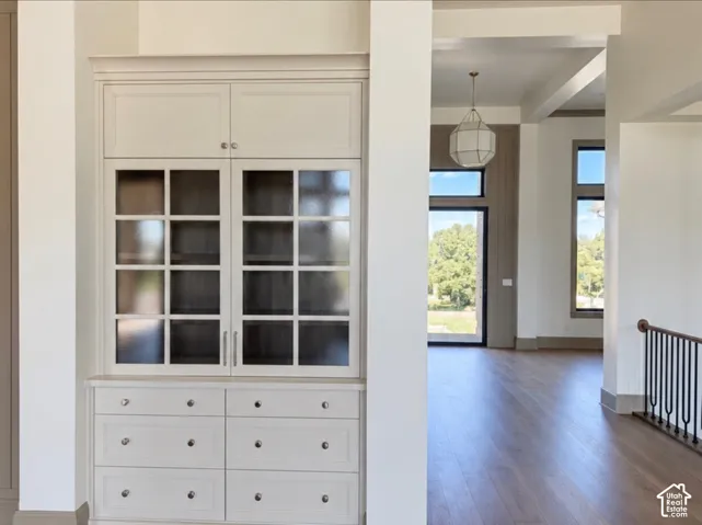 Built-in cabinetry with glass-front upper doors, lower drawers, and panel-front storage
