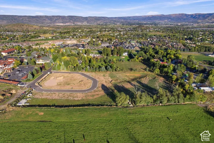 Expansive undeveloped lot with partial paved road frontage