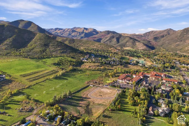 Expansive mountainous landscape with natural terrain and lush green fields