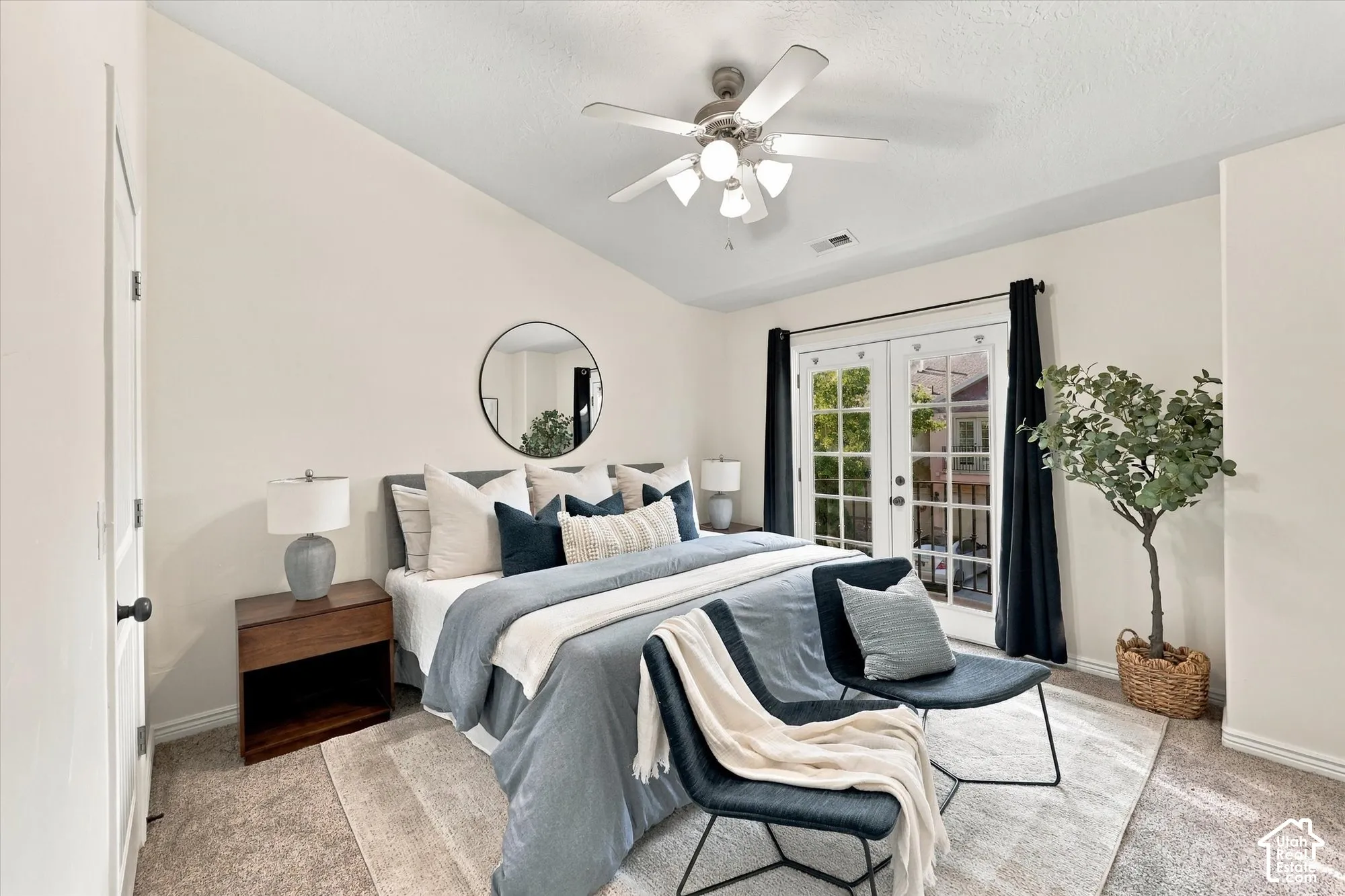 Vaulted ceiling with a ceiling fan, French doors to balcony, and brand new carpet