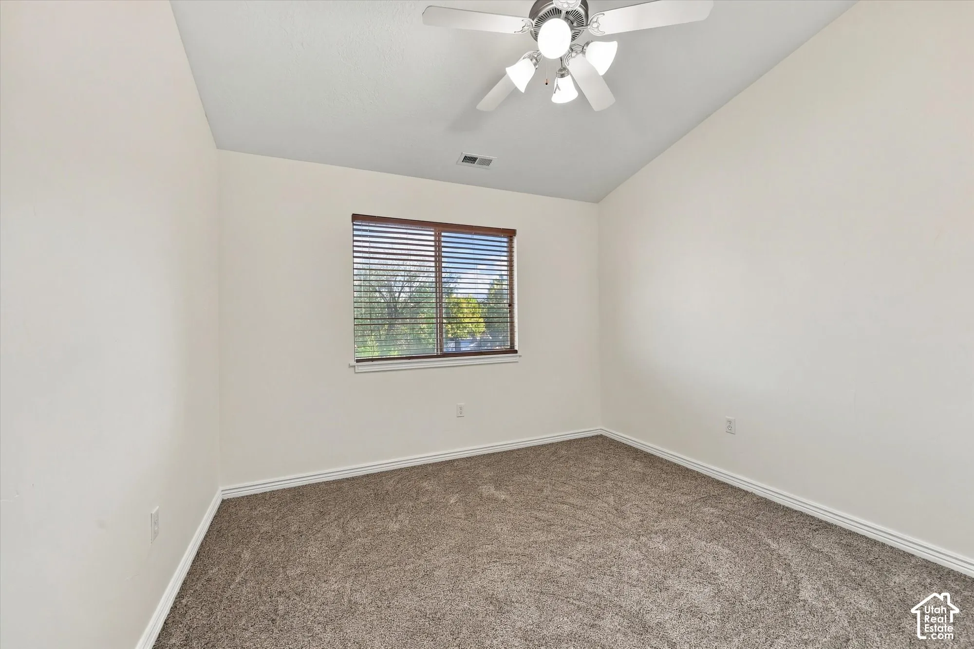Bedroom with new paint and new carpet, a ceiling fan, and a built-in closet