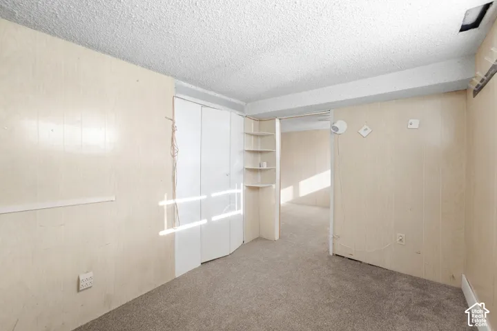 Basement bedroom with new carpet.