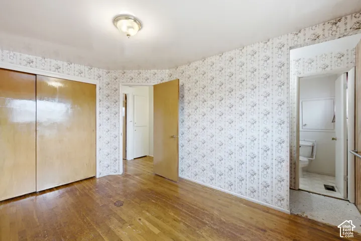 Wood-finish flooring with a ceiling-mounted light fixture