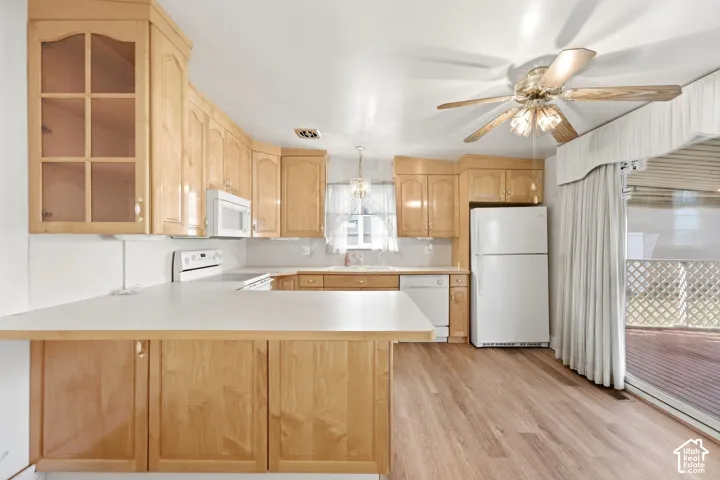 New LVP flooring, light wood cabinetry, white countertops, built-in appliances, and a sliding glass door
