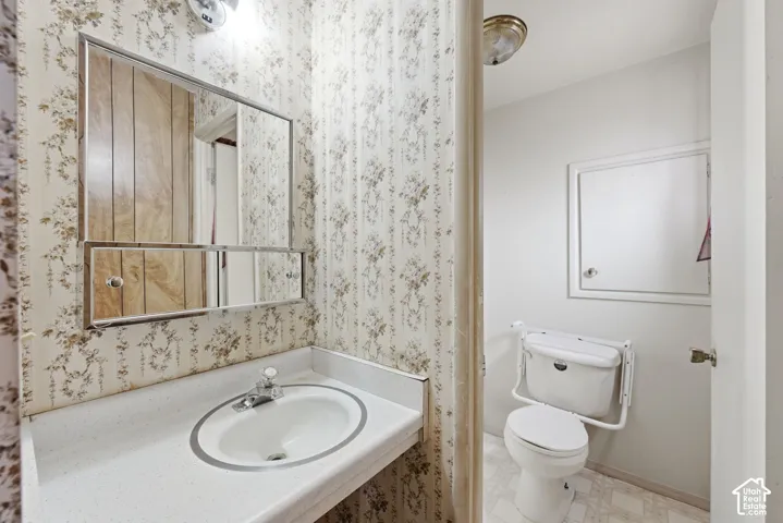 Built-in vanity with integrated sink, chrome faucet, and mirrored medicine cabinet