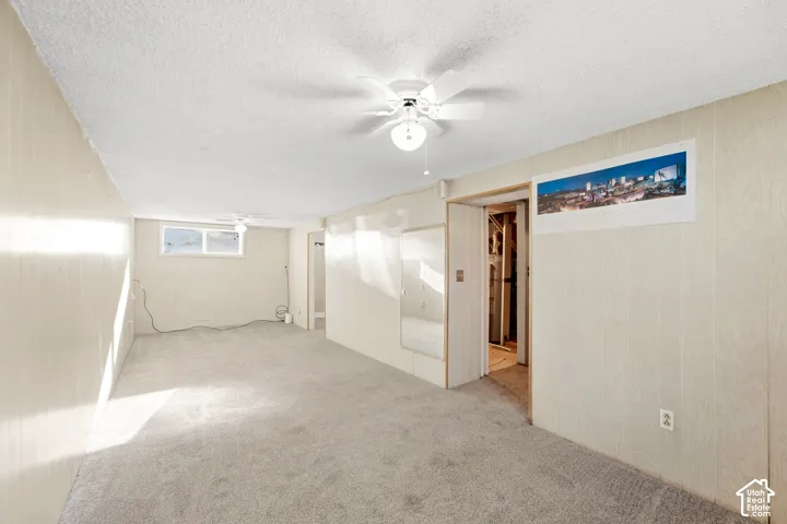 New carpeting, paneled walls, and built-in ceiling fans