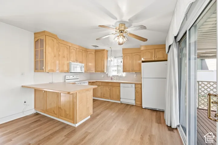 New LVP Flooring,Light wood-finish cabinetry with glass-front accents, white appliances, and a built-in breakfast bar