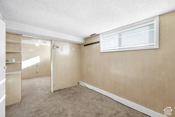 Basement bedroom with new carpet.
