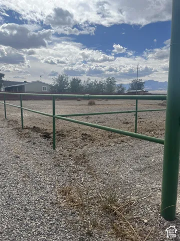 Gravel ground surface with a green pipe fence