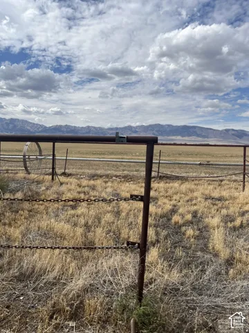 Expansive open land with a mountain backdrop