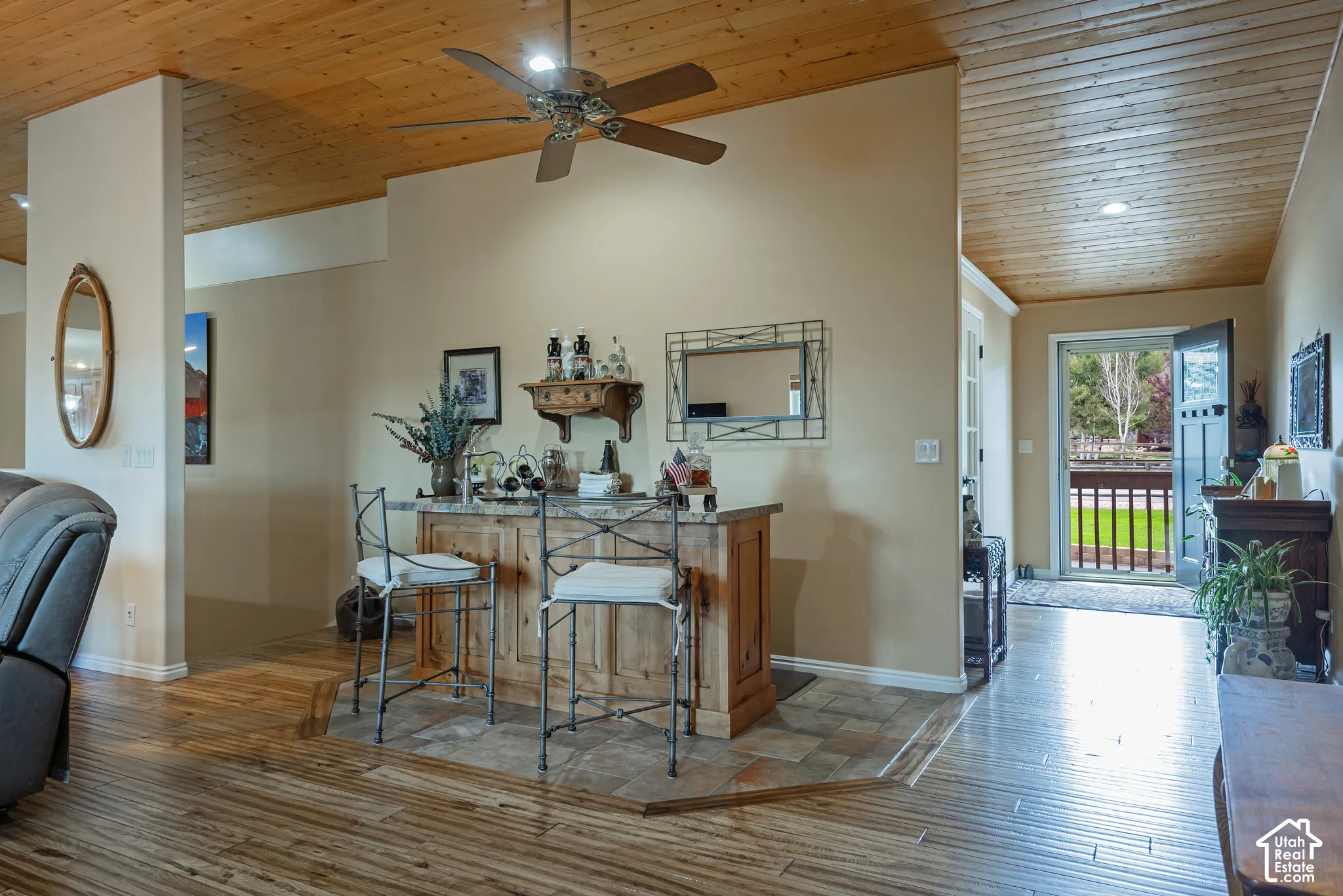 Wood-finish ceiling with recessed lighting and a ceiling fan