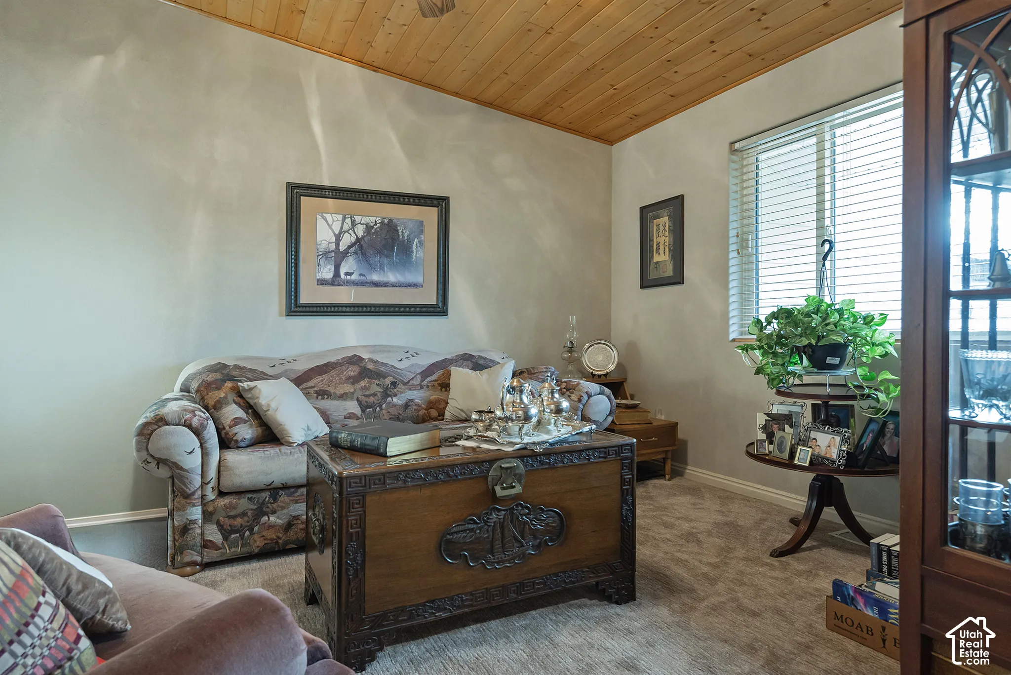 Wood-finish ceiling, light gray walls, window with blinds, and carpeting