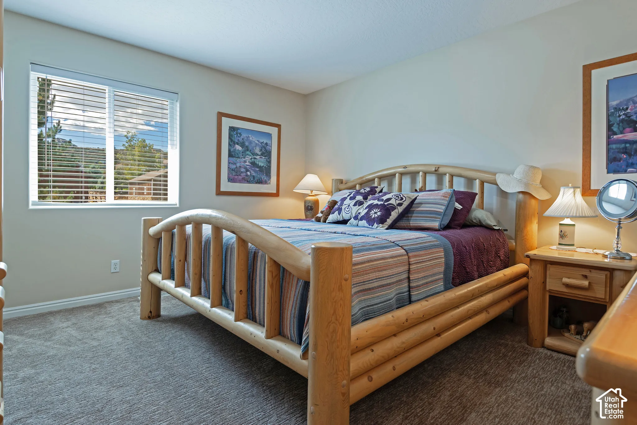 Wall-to-wall carpeting with light-toned walls and window featuring horizontal blinds