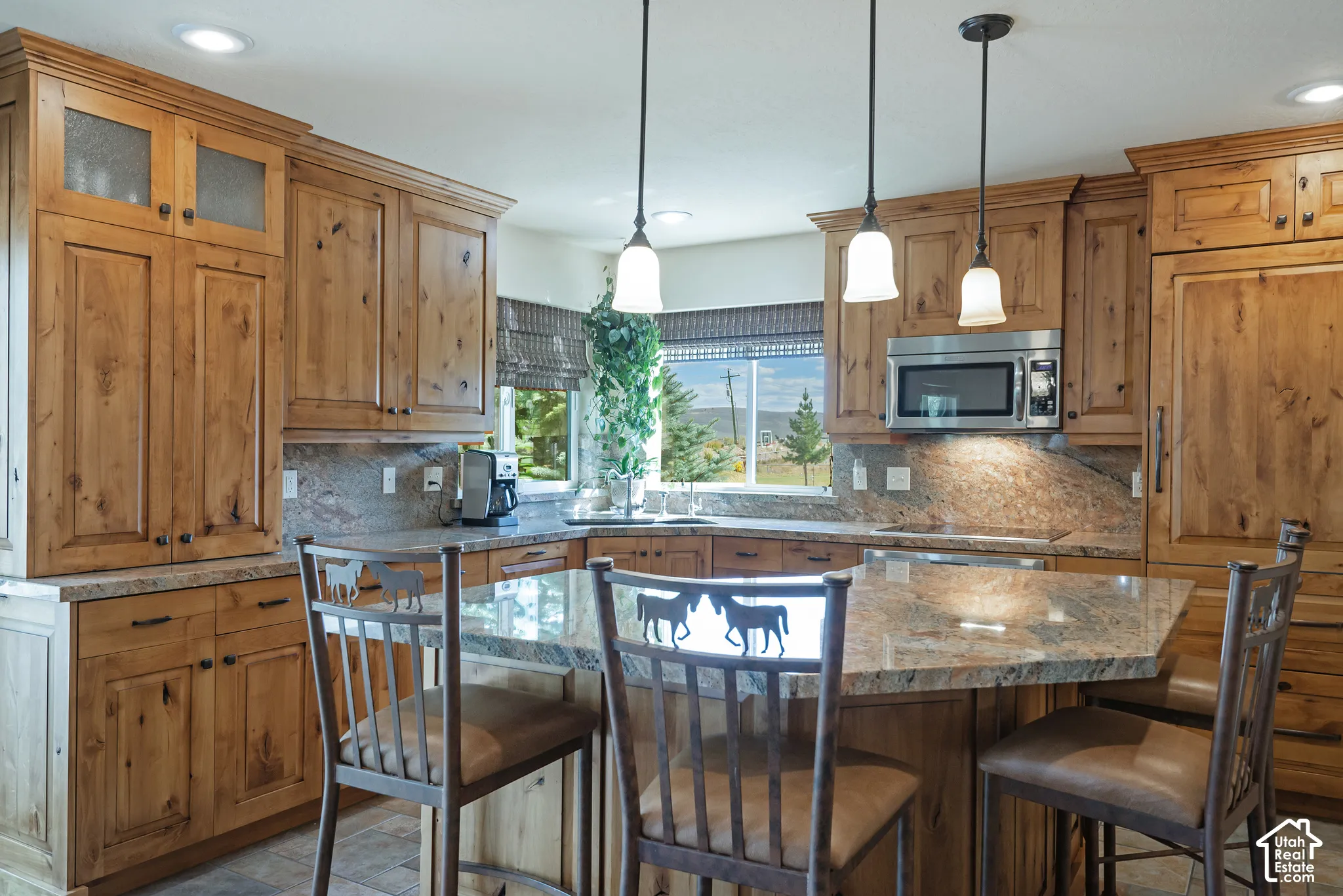 Spacious kitchen featuring extensive wood cabinetry, granite countertops, and a built-in microwave