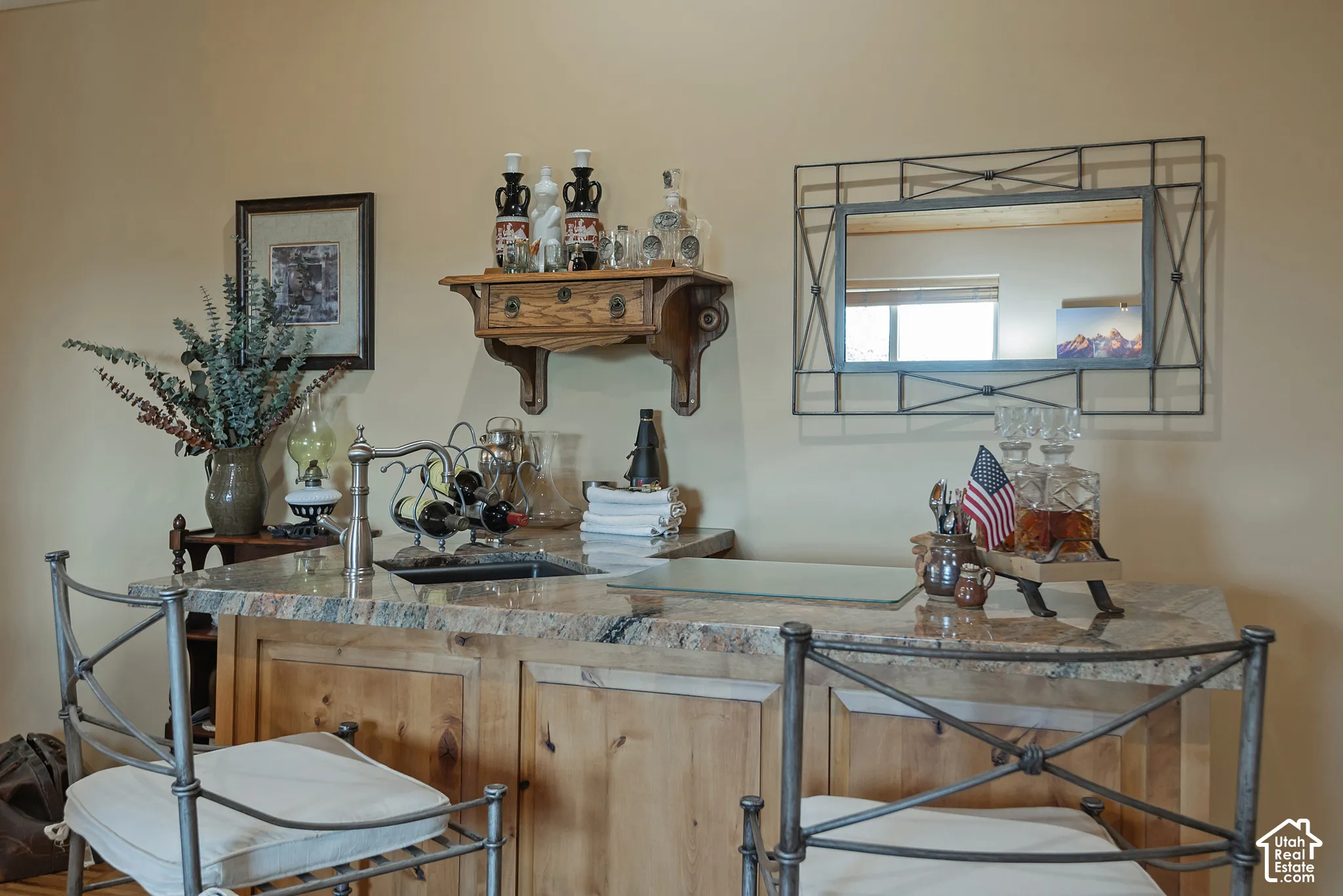 Built-in bar with stone-finish countertop, undermount sink, and wood-finish cabinetry