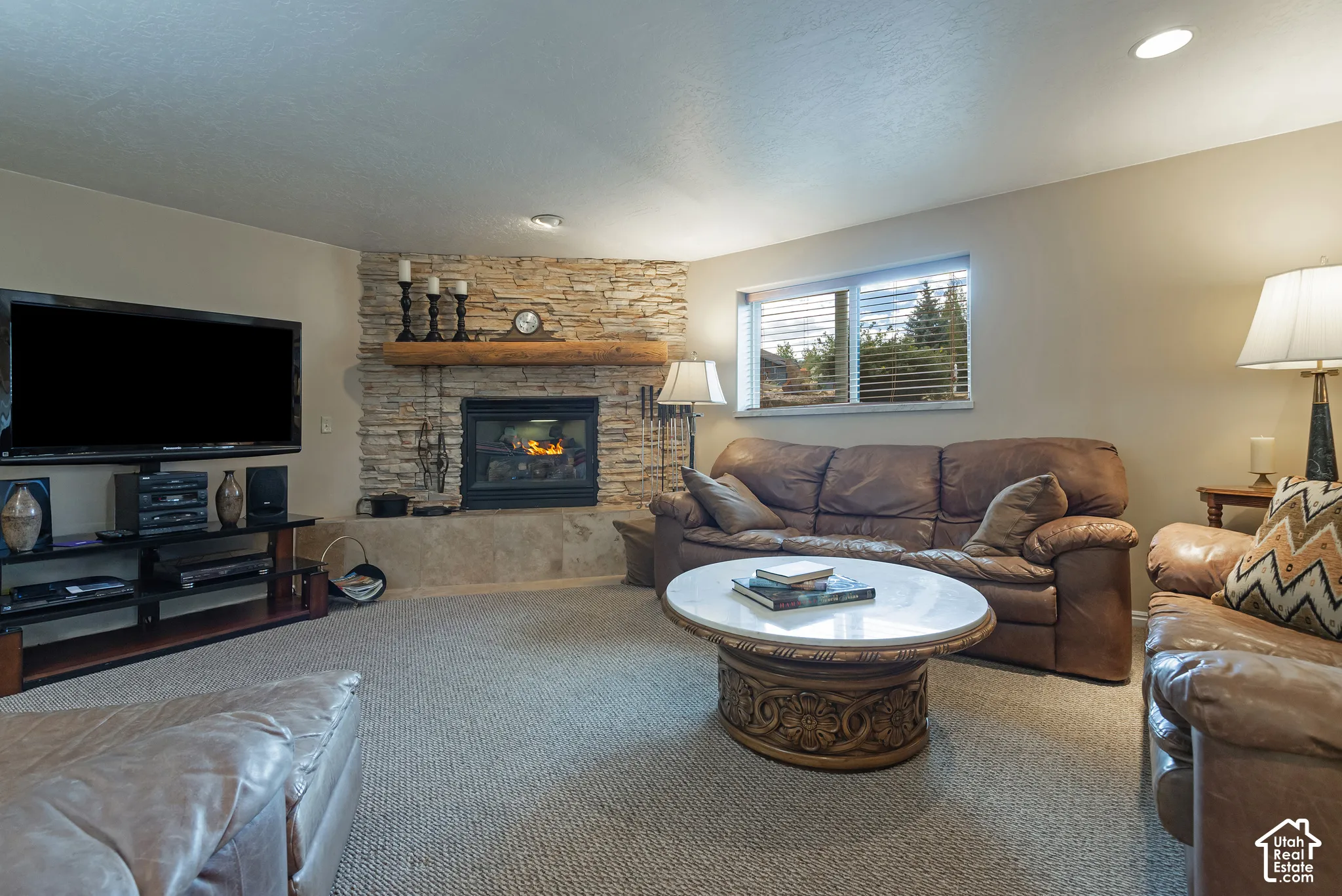 Stone-clad fireplace with a wood mantel