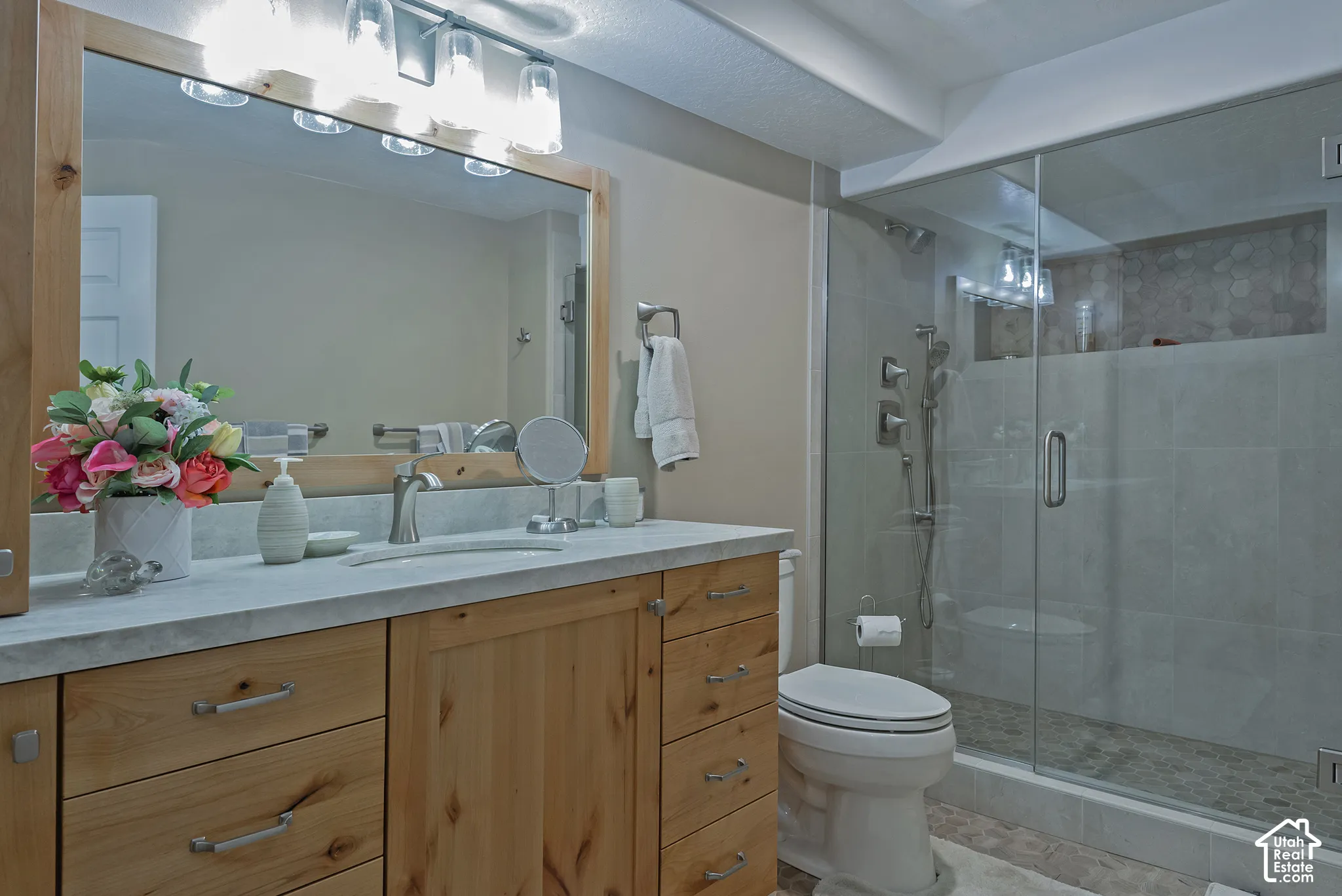 Wood-finish vanity with a light-toned countertop
