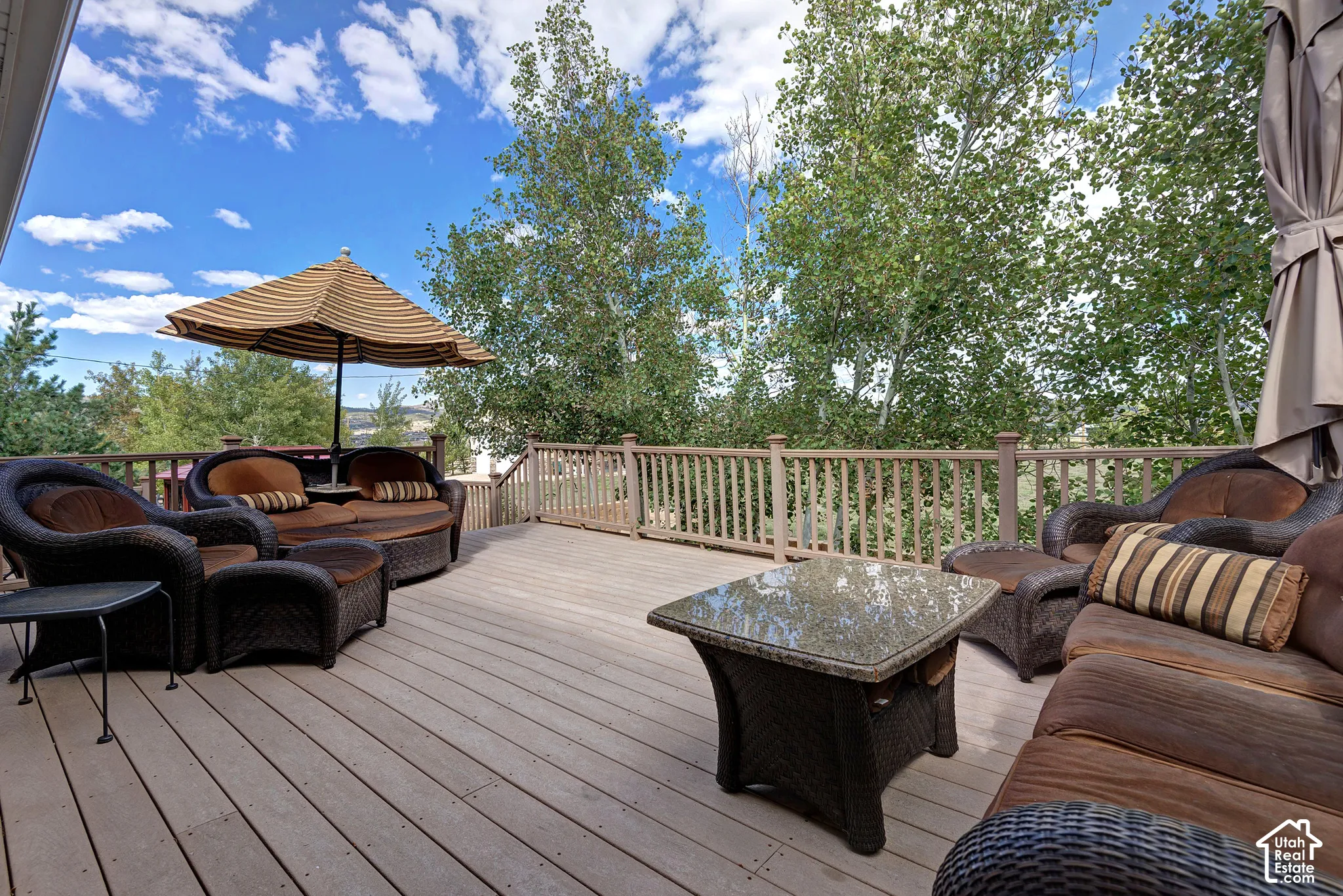 Spacious outdoor deck with wood-finish planks and a wood railing