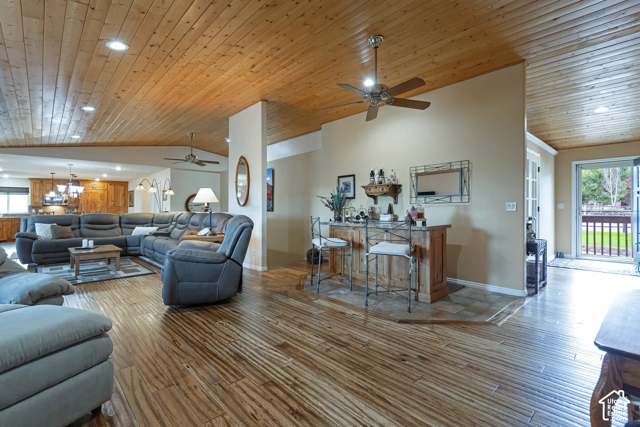 Wood-finish flooring throughout, complemented by a wood-paneled ceiling with recessed lighting