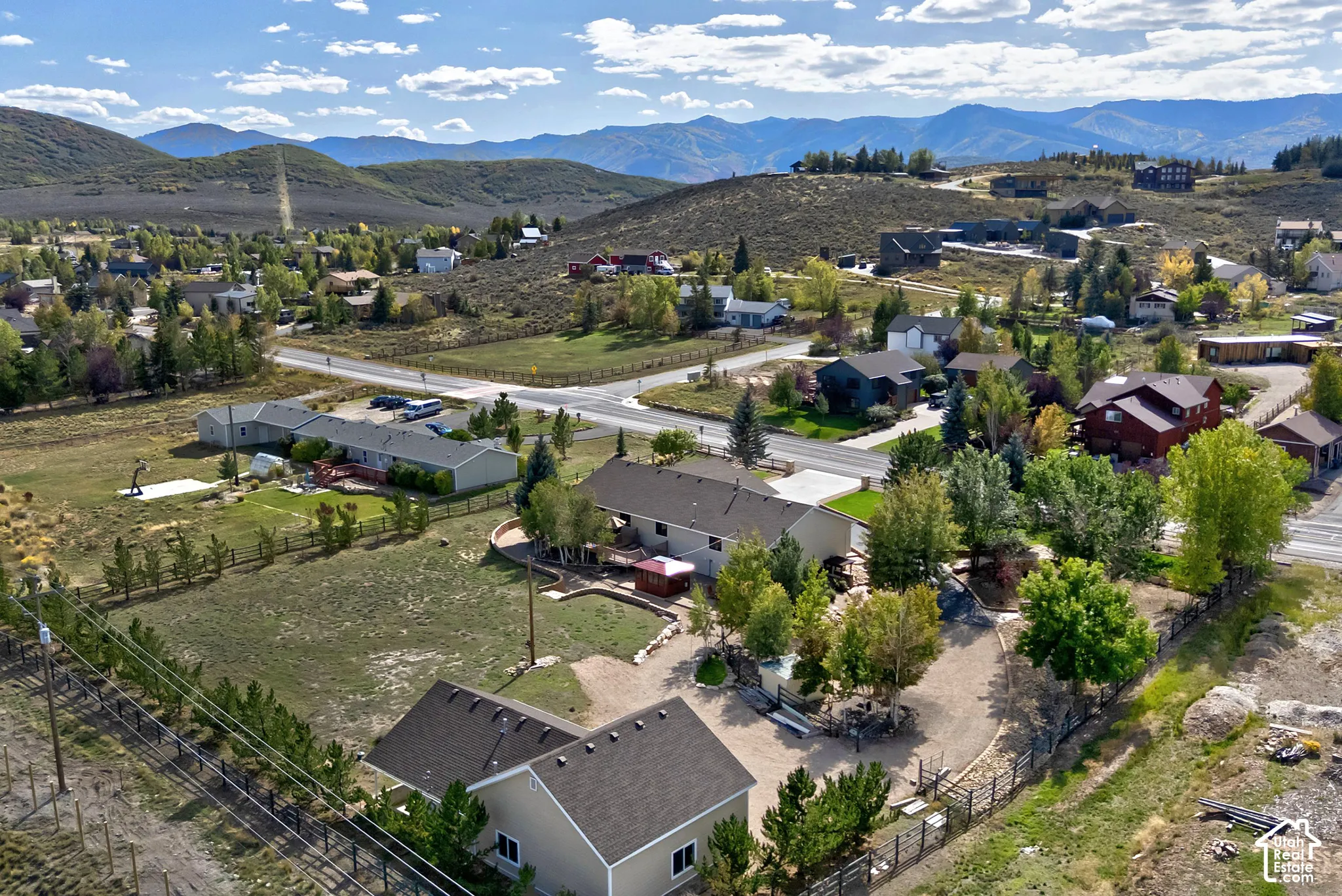 Expansive elevated lot featuring mountain backdrops and a mix of mature trees and open land