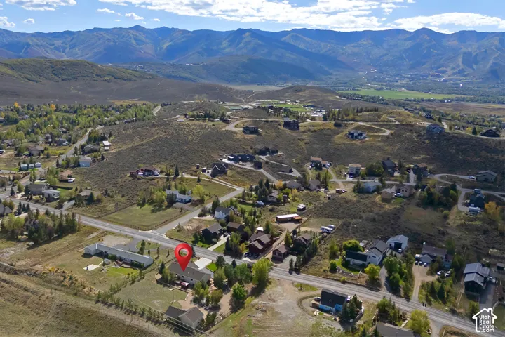 Expansive mountain backdrop with scattered residential properties