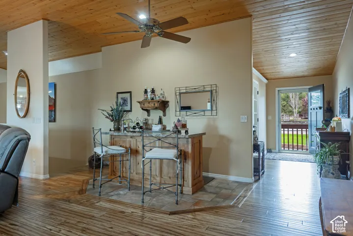 Wood-finish ceiling with recessed lighting and a ceiling fan