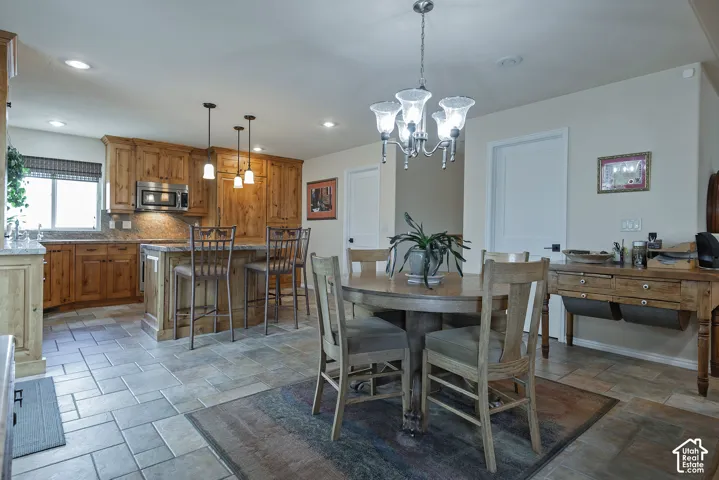 Kitchen featuring wood cabinetry, stainless steel microwave, and granite countertops