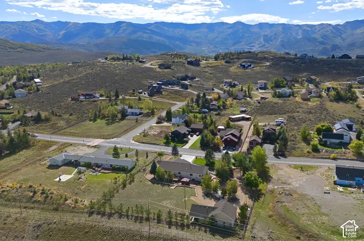 Expansive mountain scenery with residential properties situated on rolling terrain