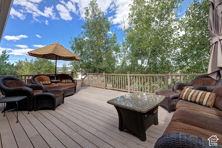 Spacious outdoor deck with wood-finish planks and a wood railing