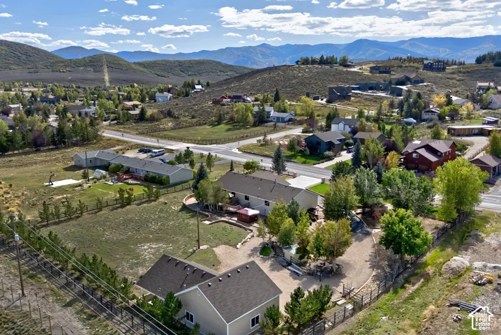 Expansive elevated lot featuring mountain backdrops and a mix of mature trees and open land