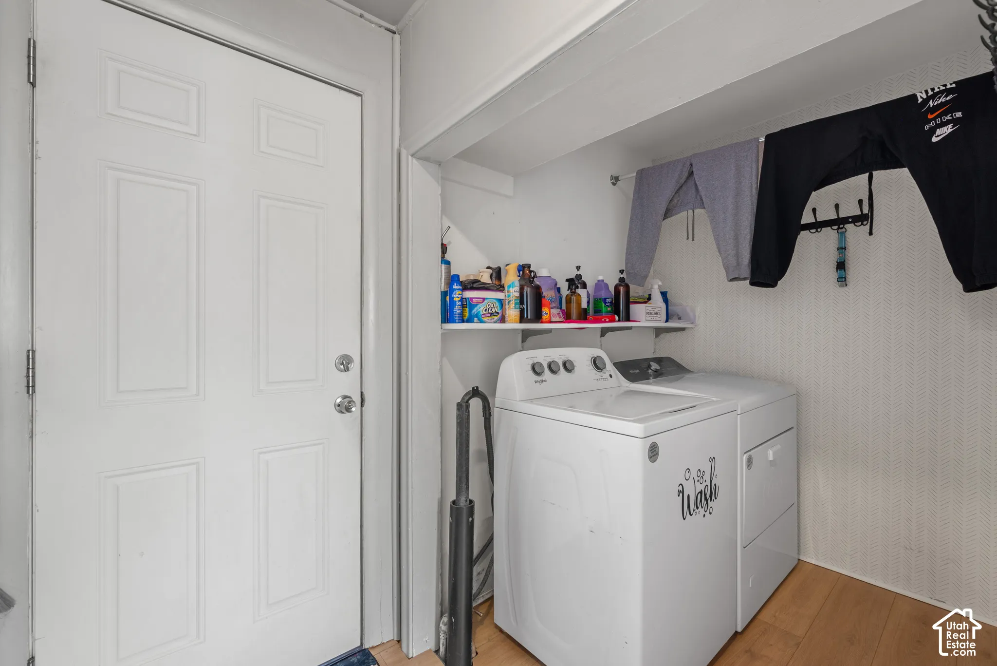 Dedicated laundry area featuring a white top-load washing machine and a white dryer
