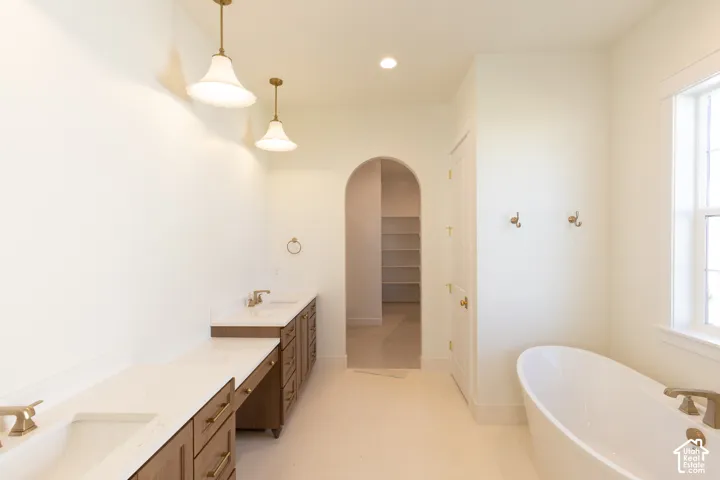 Dual vanities with undermount sinks and brass-finish fixtures